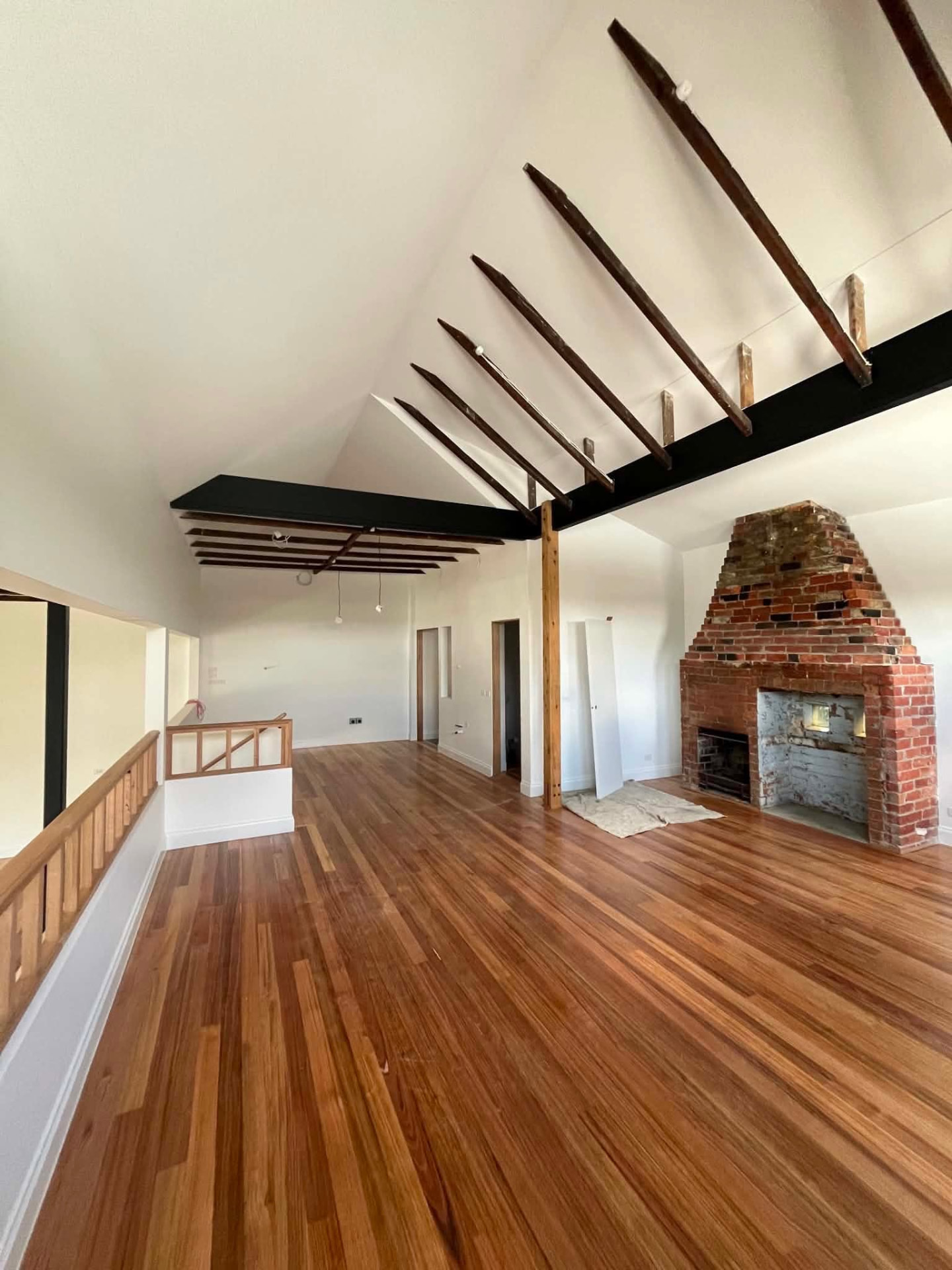 Renovated living room with a painted fireplace surround