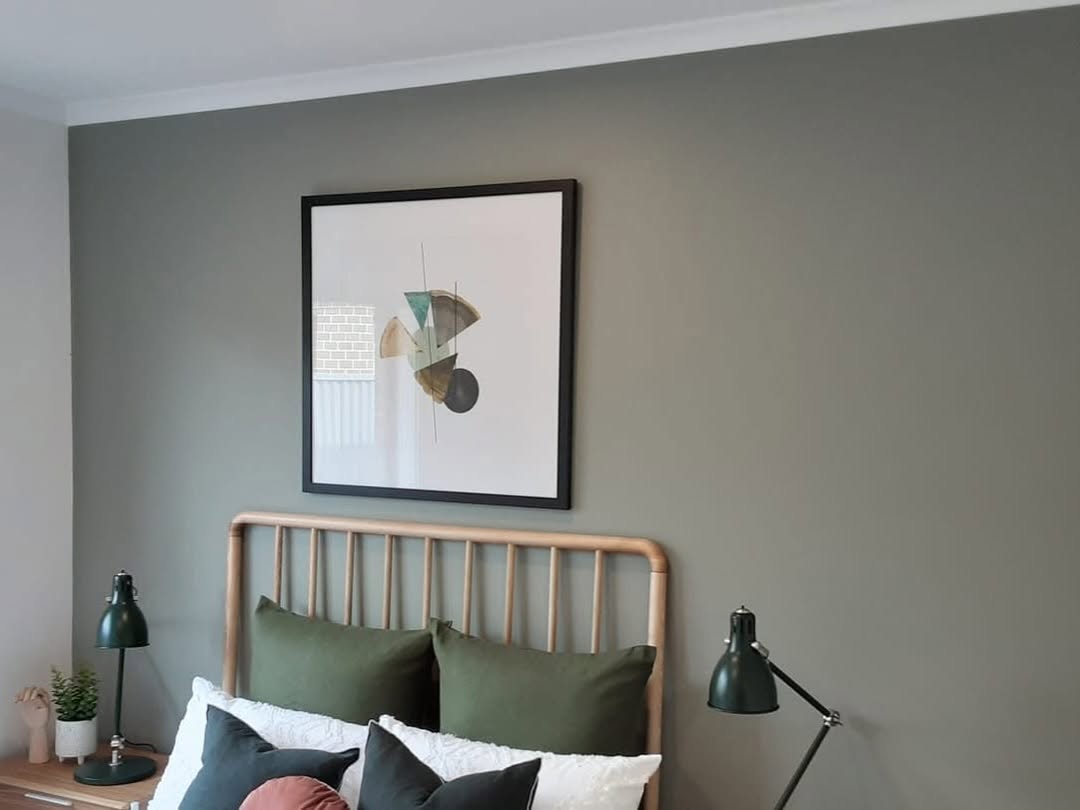 Bedroom with a feature wall painted in a deep green